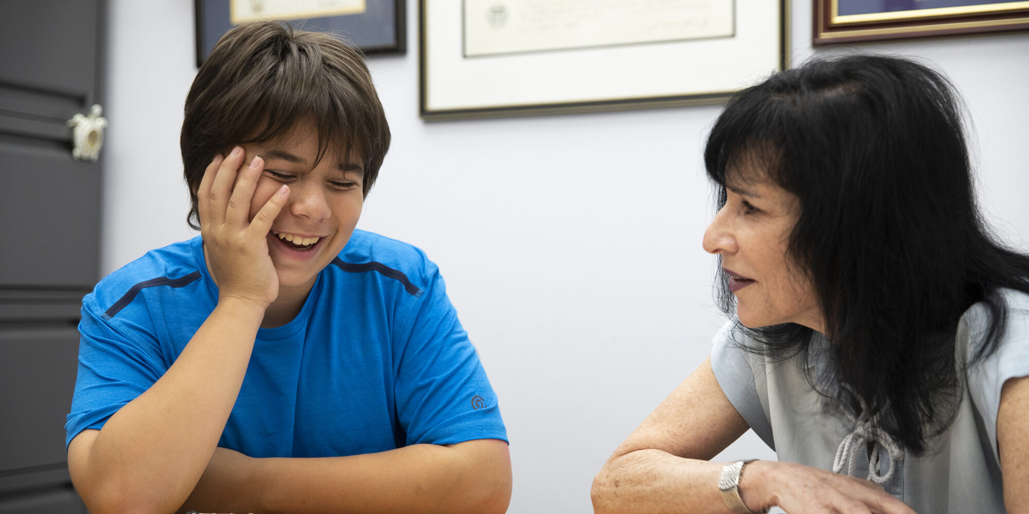 Linda Leibowitz in a counseling session with a middle grades boy who is laughing
